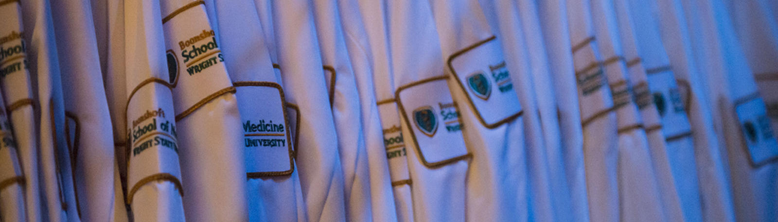 photo of a rack of white coats