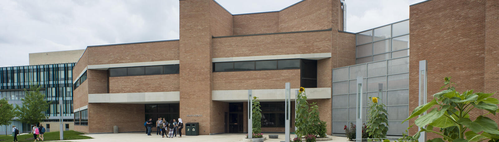 photo of students standing outside of the health sciences building