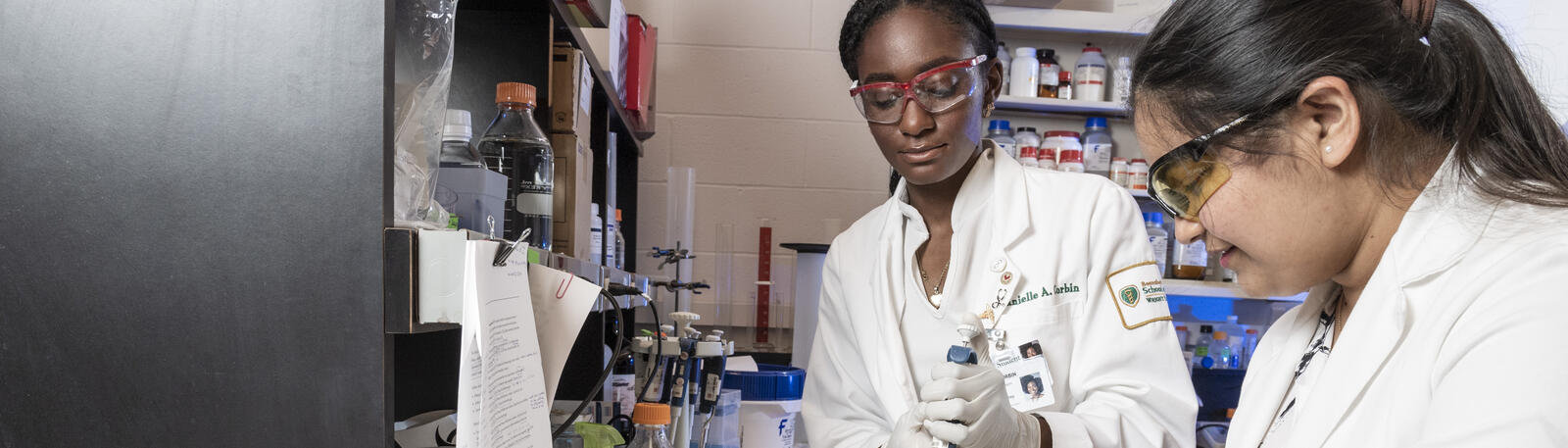 photo of two students working in a lab