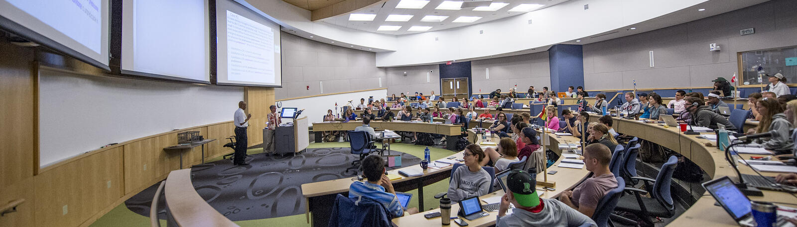 photo of a professor and students in a lecture hall