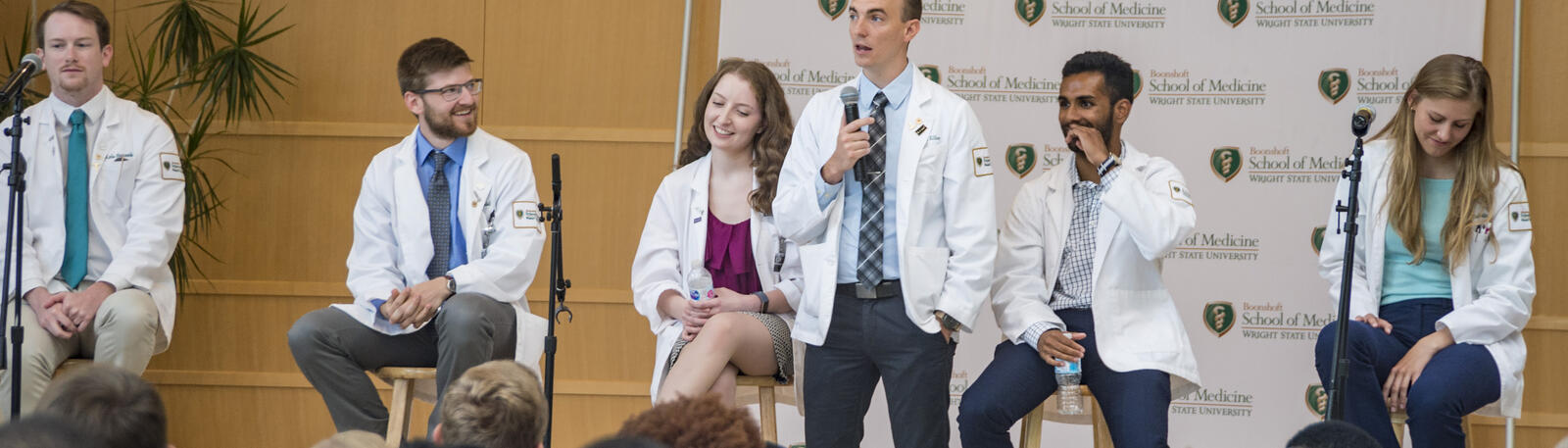 photo of medical students speaking to a crowd of people