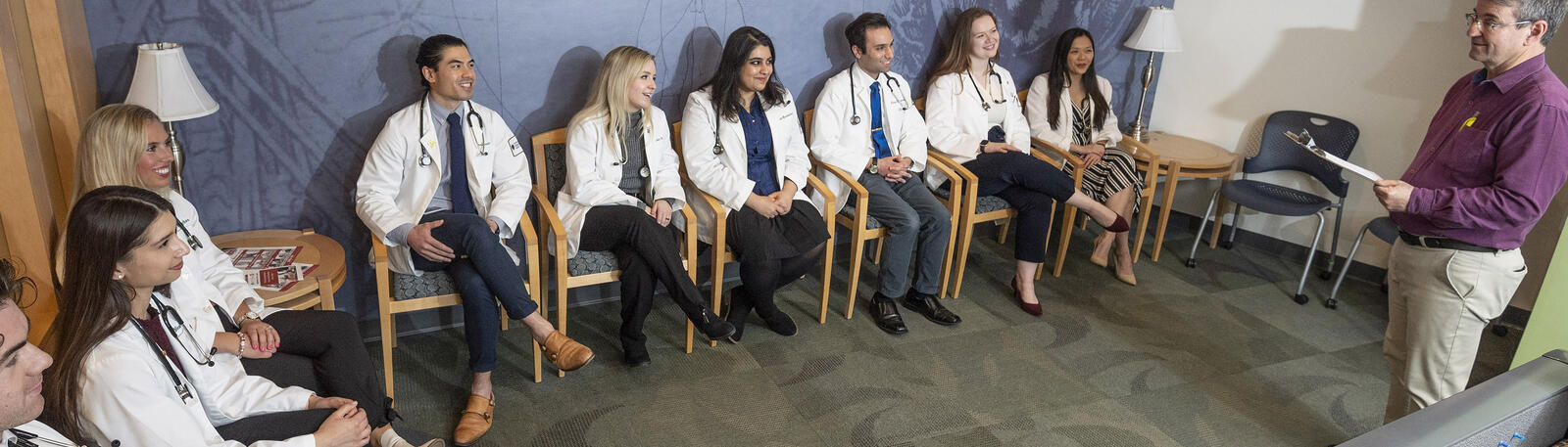 photo of medical students and a professor speaking to them