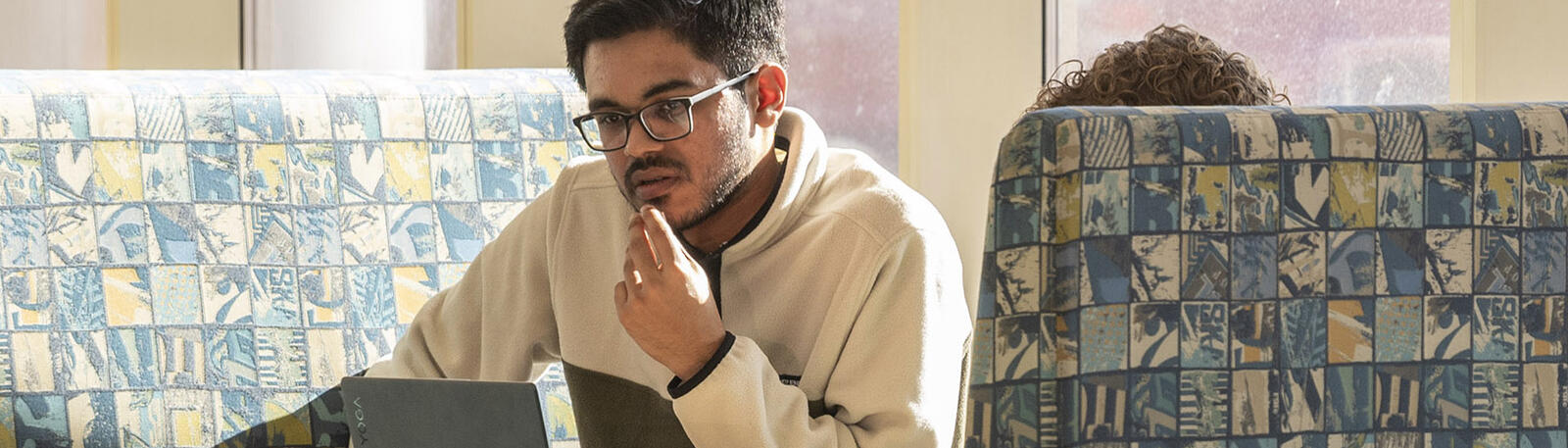 photo of a student studying in white hall