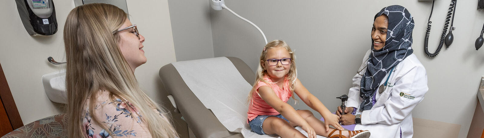 photo of a resident and patient in an exam room