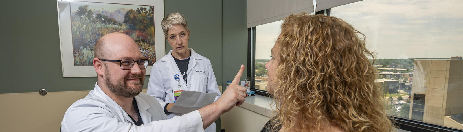 photo of a student, professor, and patient