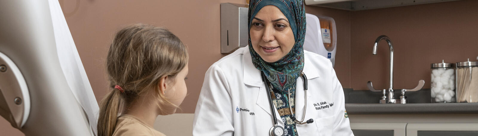 photo of a resident and patient in an exam room