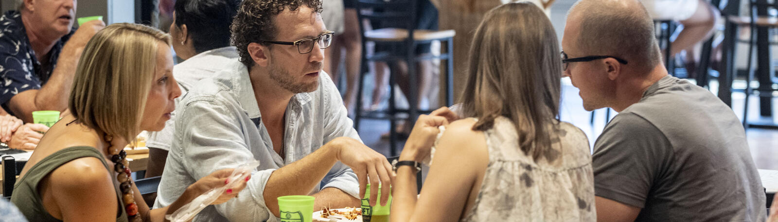 photo of alumni sitting at a table at an event