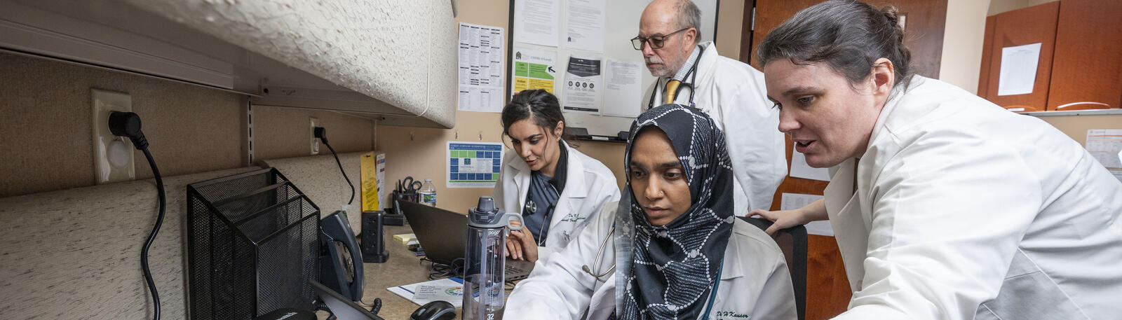 photo of residents and physicians in an office