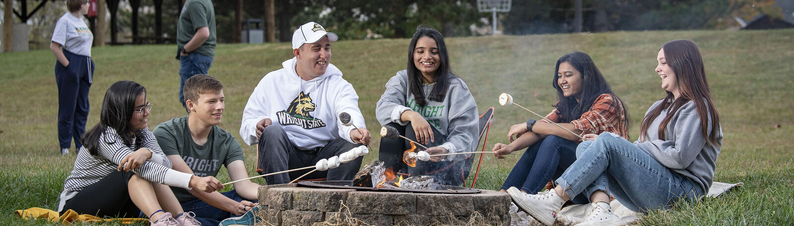 photo of students roasting marshmallows on campus