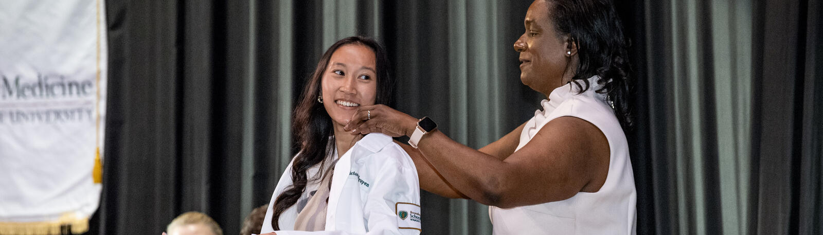 photo of a student and faculty member at the white coat ceremony