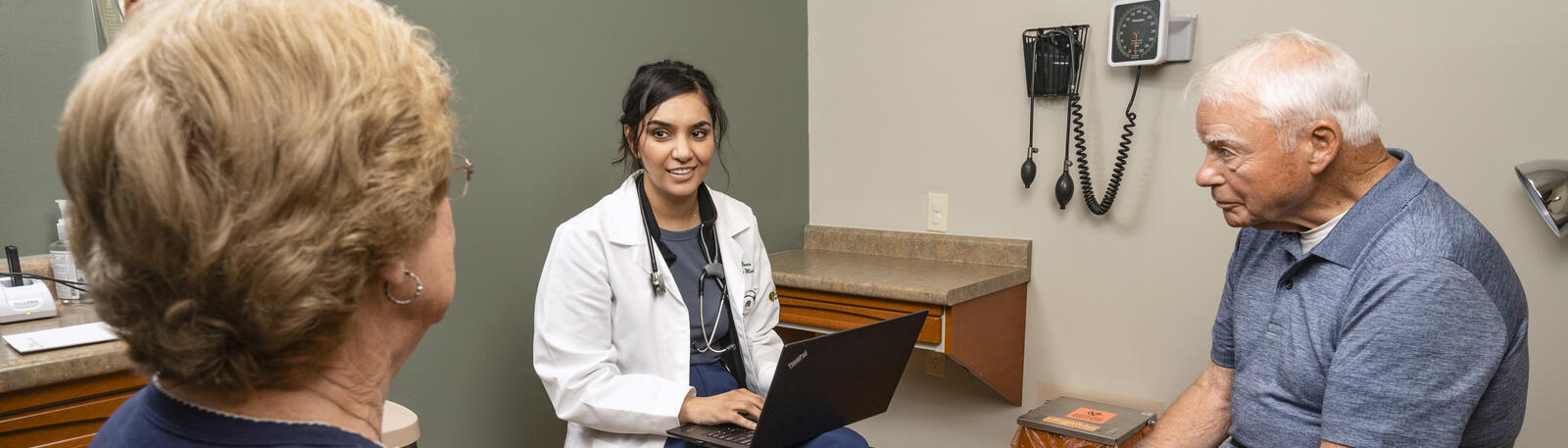 photo of a resident in an exam room with a patient