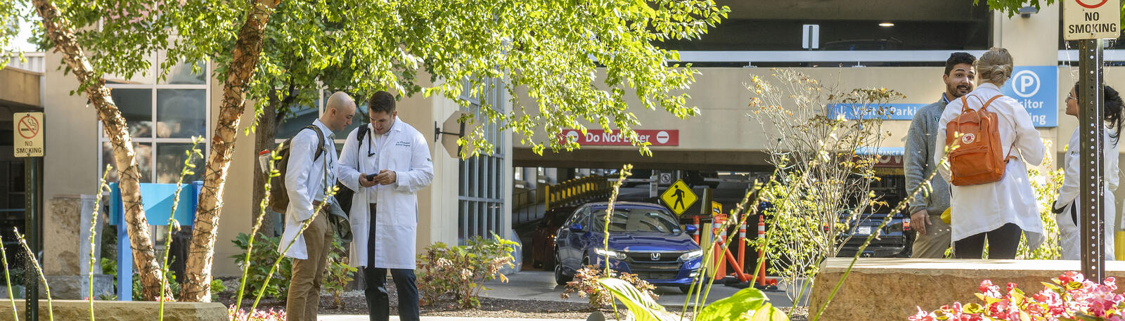 photo of physicians talking outside of a hospital