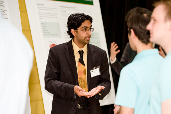 A medical student presenting a poster presentation